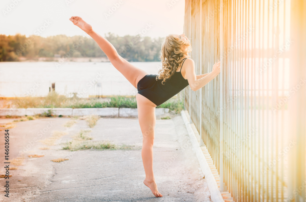 Naklejka premium Fitness. sports young woman doing stretching outdoors.