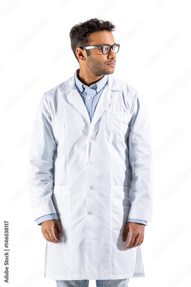 young doctor in white coat gesturing and looking at camera isolated on white young doctor in white coat gesturing and looking at camera isolated on white