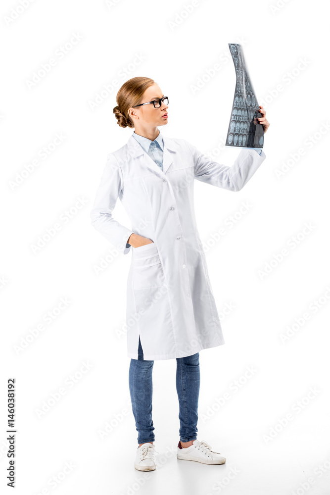 serious female doctor standing in white coat and holding X-ray isolated on white serious female doctor standing in white coat and holding X-ray isolated on white