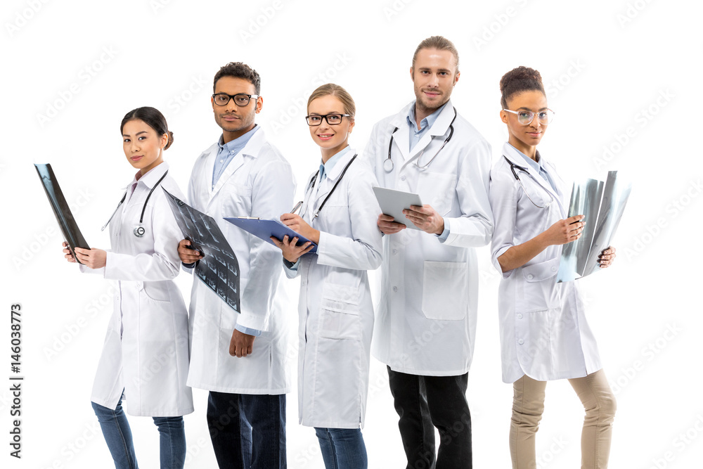 Group of young smiling professional doctors standing together isolated on white Group of young smiling professional doctors standing together isolated on white