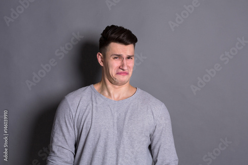 Negative human emotion, man expressing disgust