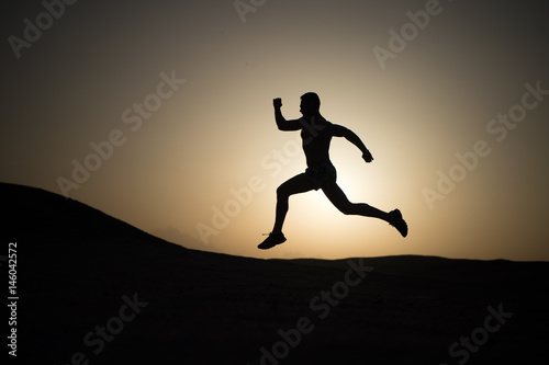 running man on mountain nature landscape on sky background © be free