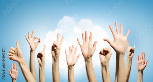 Group of people rise hands