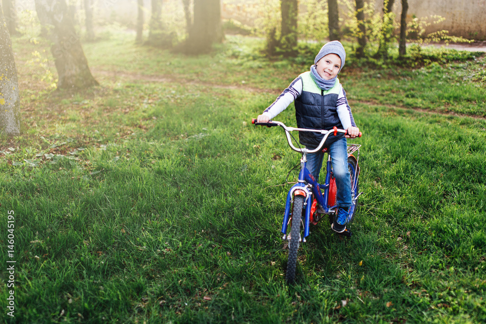Little boy with bike at park background Little boy with bike at park background