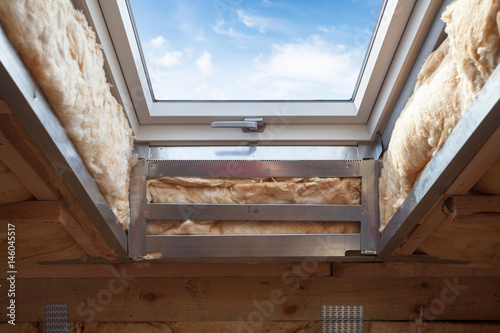 Foto Plastic (mansard) or skylight window on attic with environmentally friendly and energy efficient thermal insulation rockwool