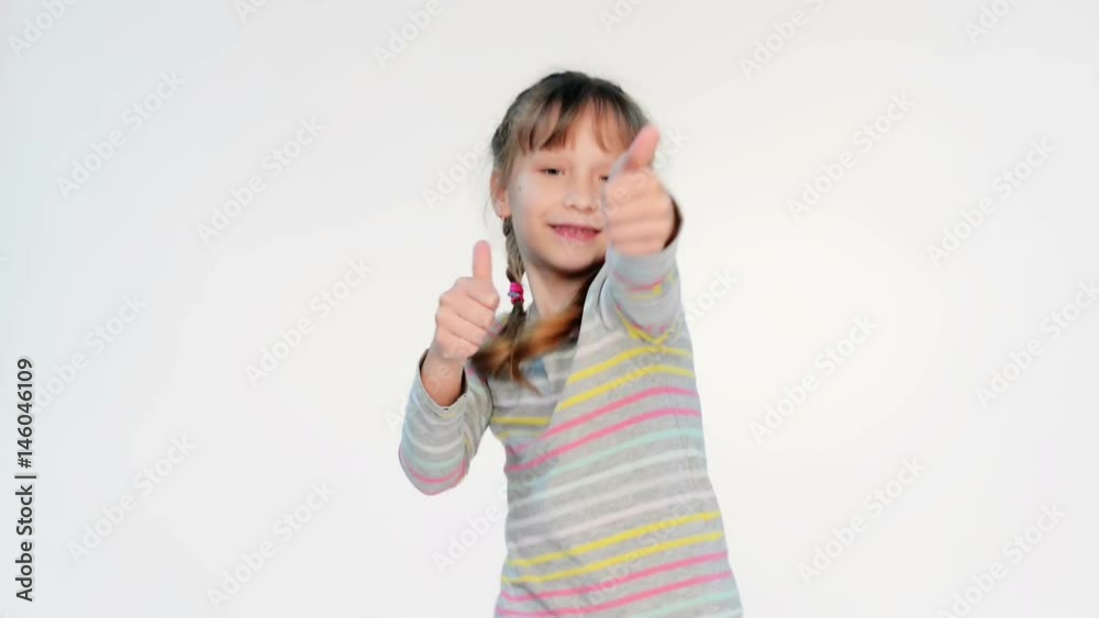 Happy little girl dancing gesturing thumb up with enthusiasm, locked down real time video Happy little girl dancing gesturing thumb up with enthusiasm, locked down real time video