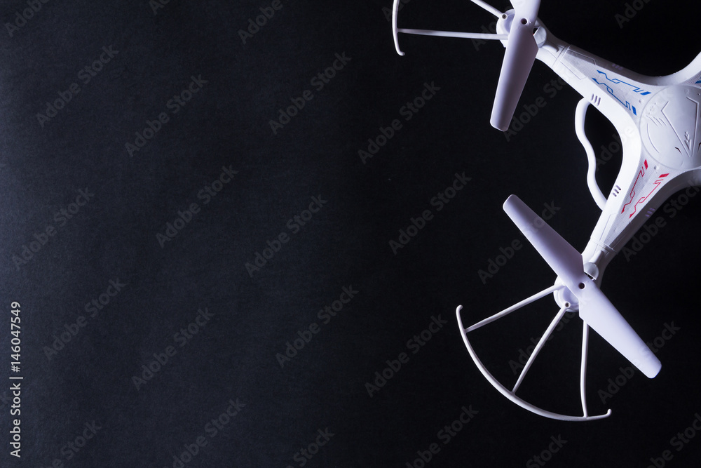 Photo of white quadrocopter on black background