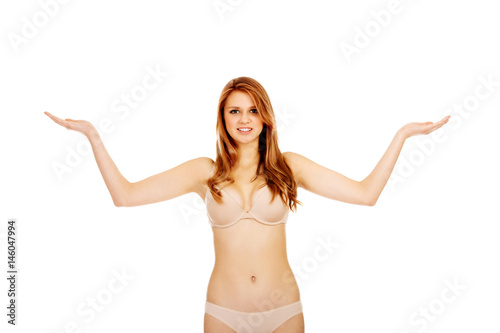 Woman in underwear presenting something on open palm 