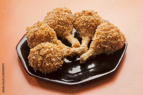 chicken lollypop on black plate