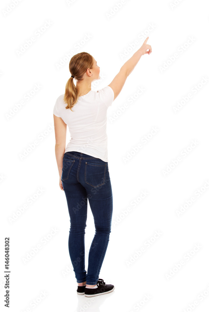Young woman pointing on copy space or something Young woman pointing on copy space or something