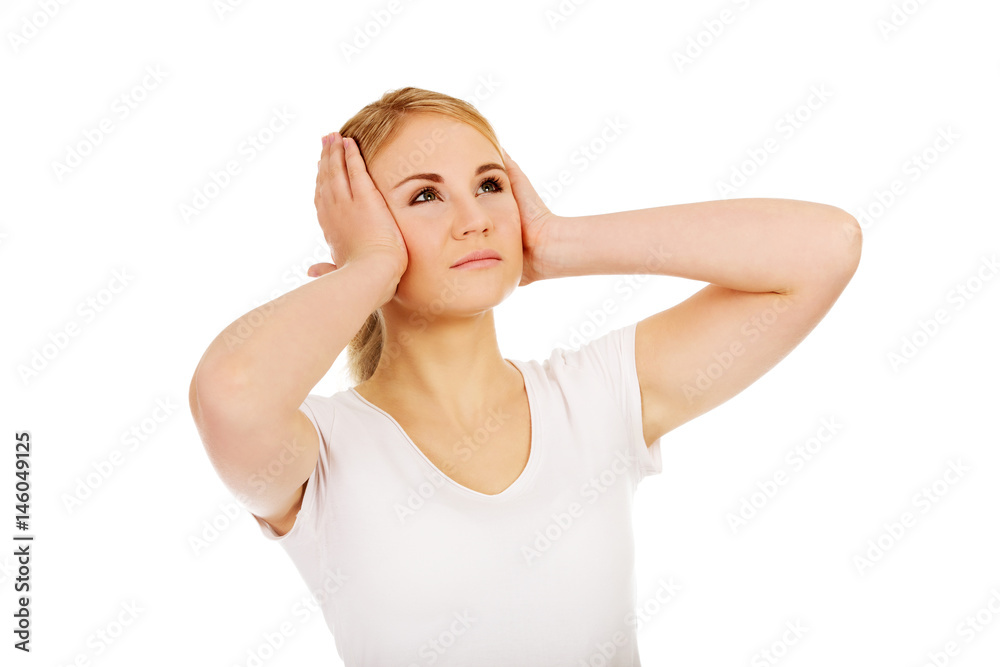 Young woman with headache holding her hand to the head Young woman with headache holding her hand to the head
