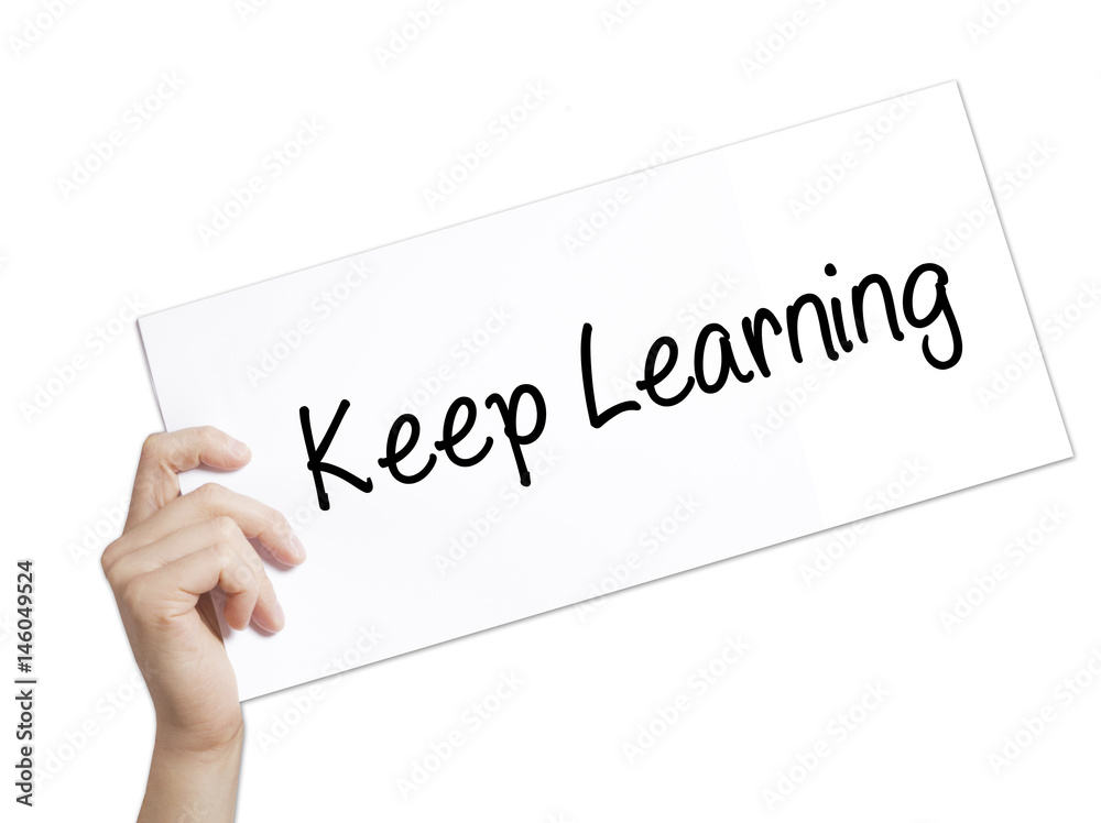 Keep Learning Sign on white paper. Man Hand Holding Paper with text. Isolated on white background Keep Learning Sign on white paper. Man Hand Holding Paper with text. Isolated on white background