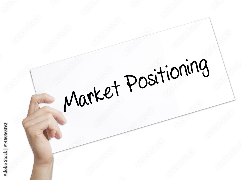 Market Positioning Sign on white paper. Man Hand Holding Paper with text. Isolated on white background. Market Positioning Sign on white paper. Man Hand Holding Paper with text. Isolated on white background.