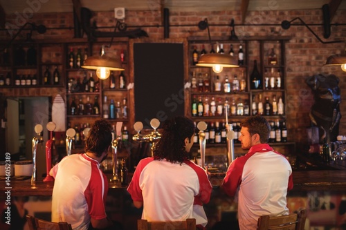 Group of male friends sitting at counter