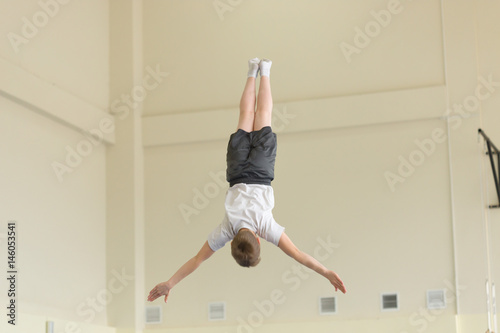 Fototapeta Naklejka Na Ścianę i Meble -  GOMEL, BELARUS - 22 April 2017: Freestyle competitions among young men and women in 2004-2006. In the program trampoline and gymnastic path
