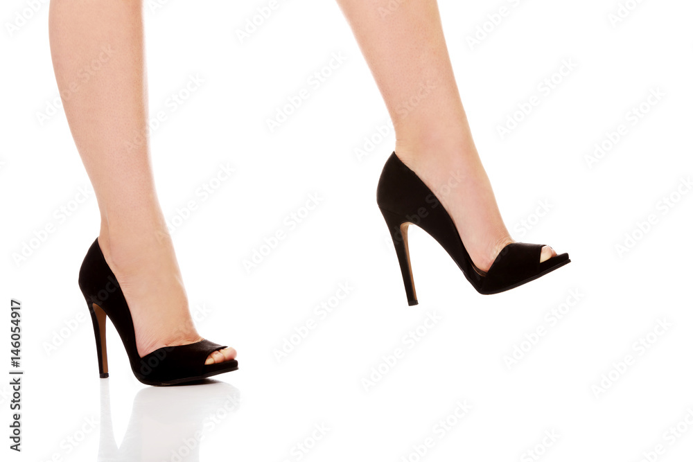 Woman's leg in high heels trying to trample something Stock Photo | Adobe  Stock