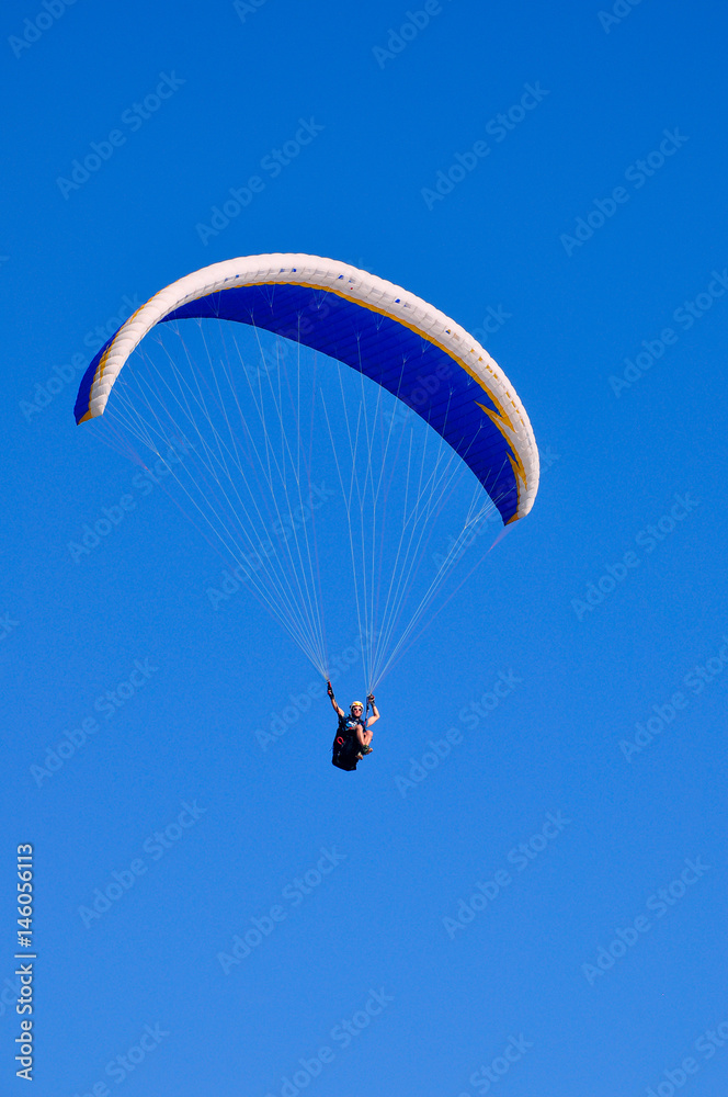 The pilot controls the paraglider in the sky The pilot controls the paraglider in the sky