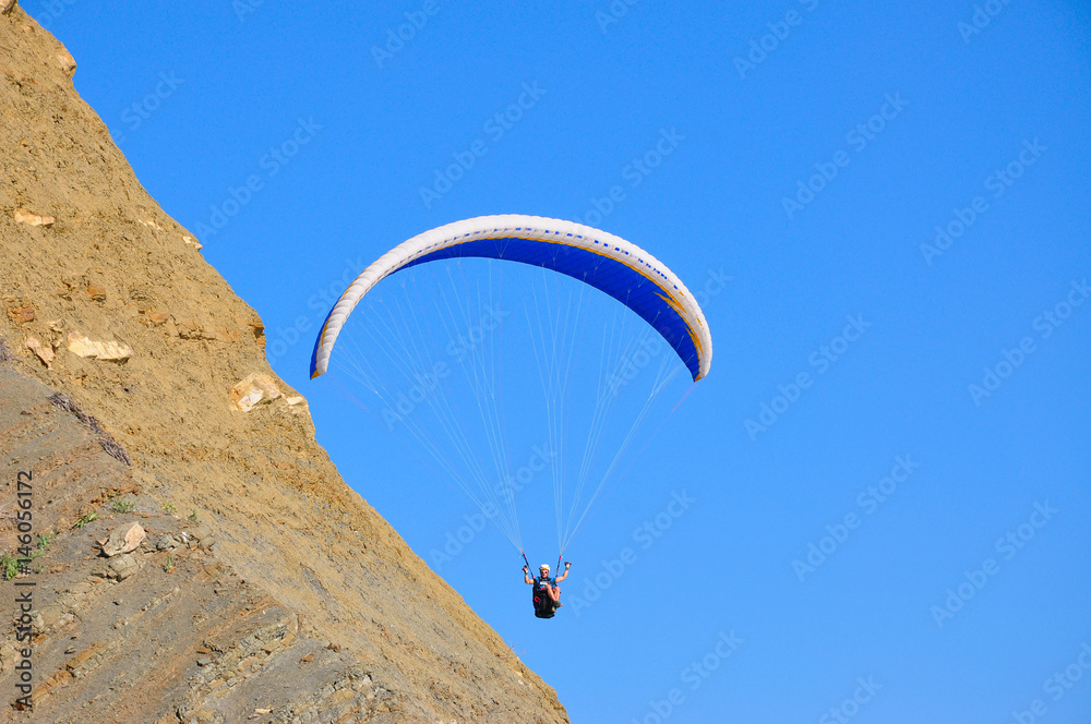 paraglider in the air over the mountains