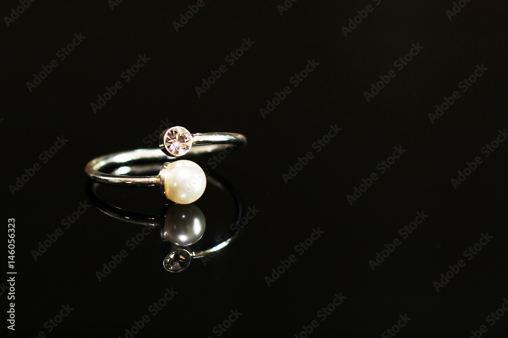 Beautiful wedding rings on a black glossy surface