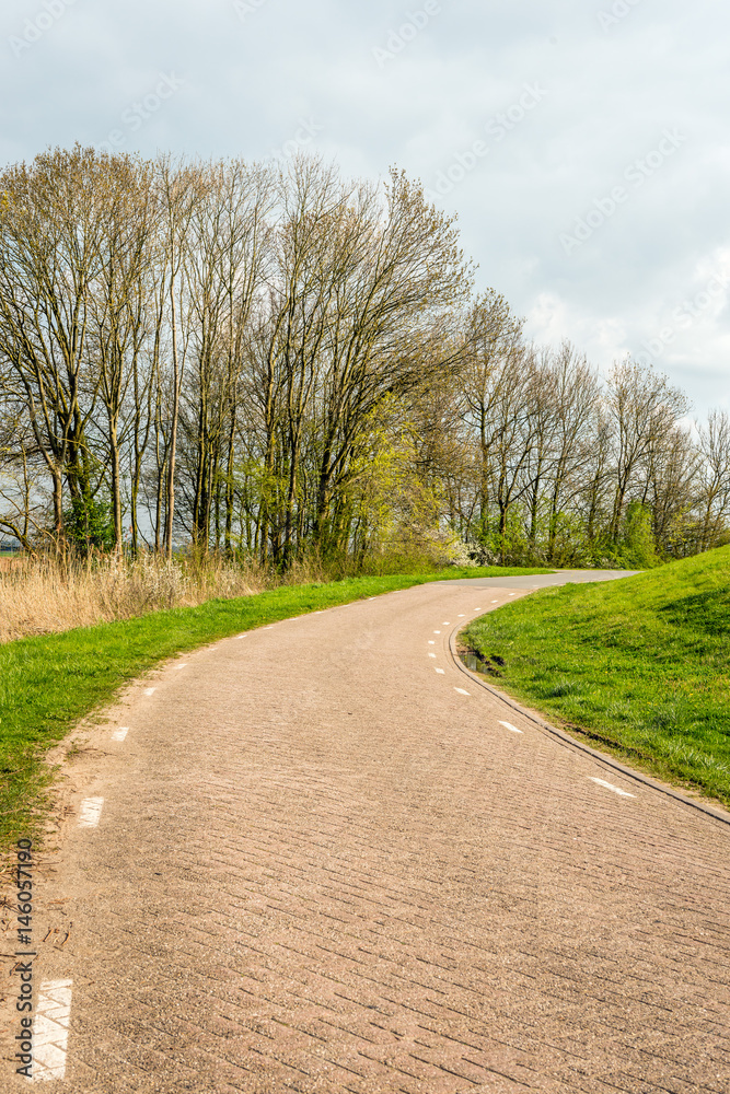 Bend in a country road with paving stones and white stripes Bend in a country road with paving stones and white stripes