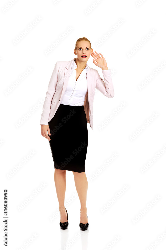 Young woman overhears conversation and laughing Young woman overhears conversation and laughing