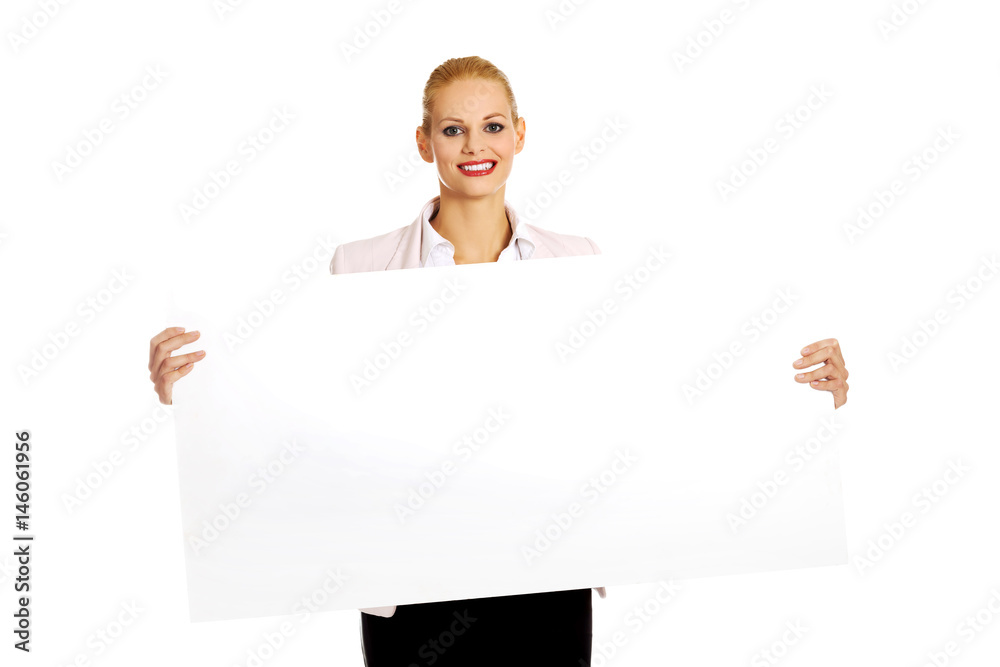 Smiling young businesswoman holding blank banner Smiling young businesswoman holding blank banner
