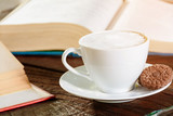 coffee cup and book on old wood