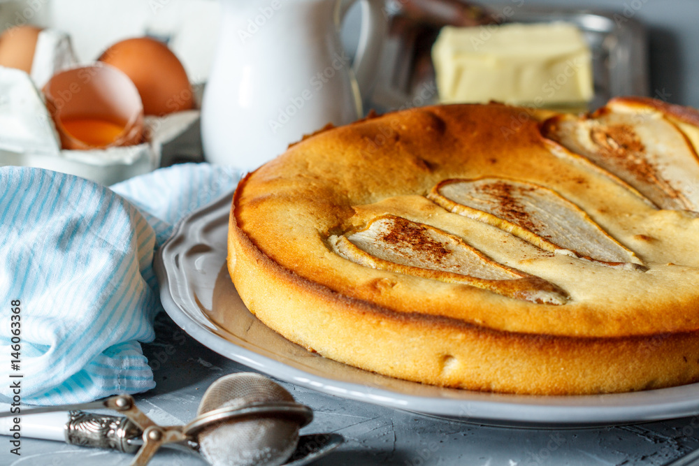 Fruit pie with pears on the background of ingredients (eggs, milk, butter). Fruit pie with pears on the background of ingredients (eggs, milk, butter).