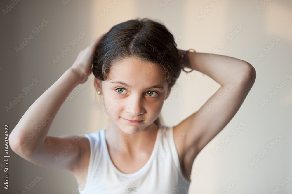 beautiful little girl doing her hair beautiful little girl doing her hair