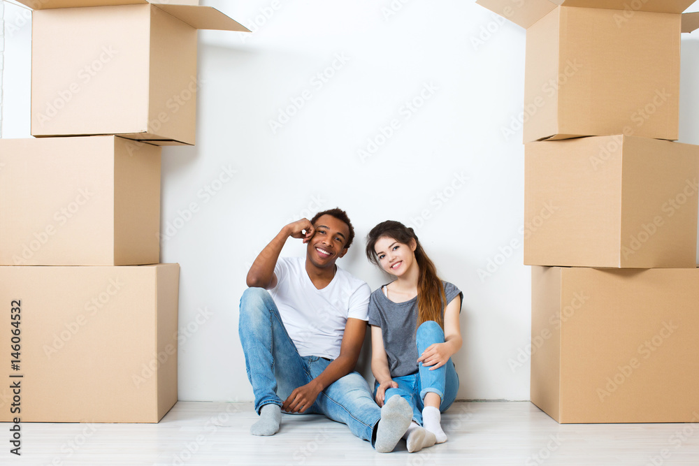 Happy young couple sitting on floor dreaming. Happy young couple sitting on floor dreaming.