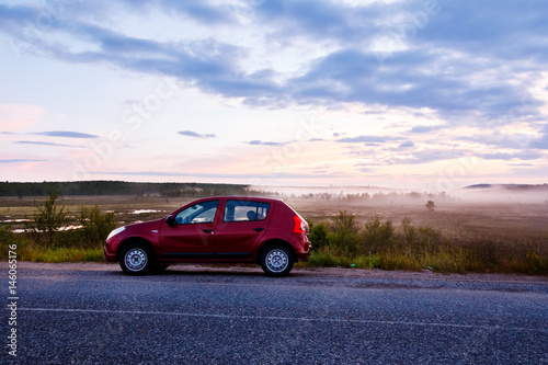 car is at sunrise. In the background  the fog. Concept trip weekend on car for rent. Teriberka  Kola Peninsula  Russia.