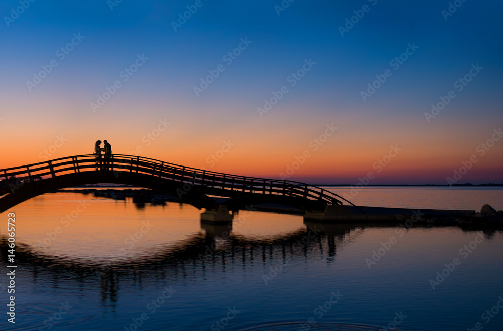 Couple enjoying the romantic sunset on the Lefkas town bridge