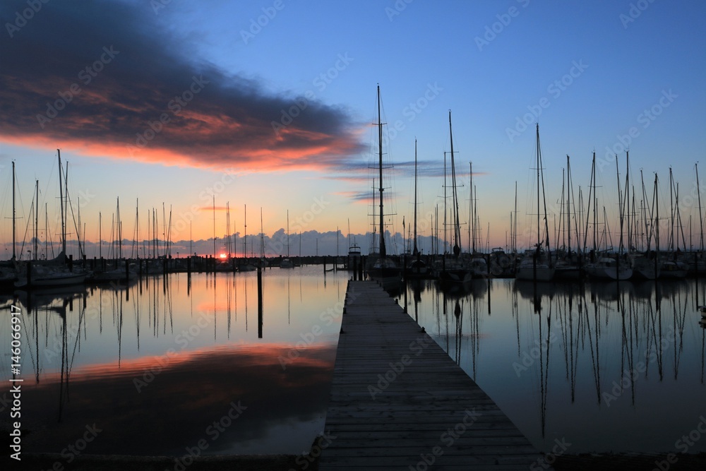 marina with jetty and sailboats at dawn marina with jetty and sailboats at dawn