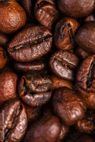 Coffee beans background macro. Dark Roasted coffee beans textured wallpaper for your design with copy space.