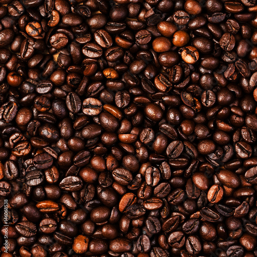 Coffee beans background macro. Dark Roasted coffee beans textured wallpaper for your design with copy space.