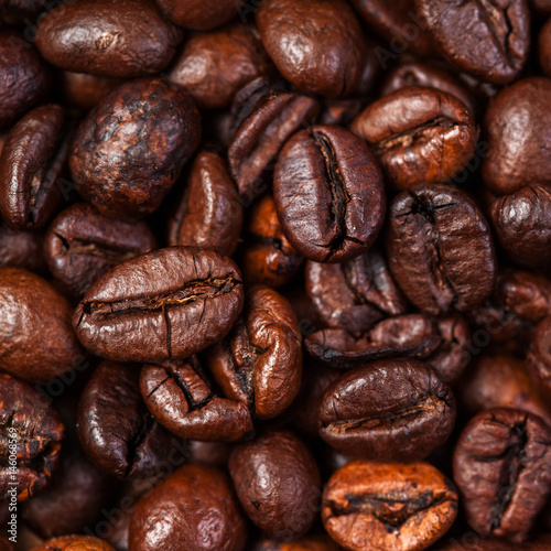 Fototapeta Naklejka Na Ścianę i Meble -  Coffee beans background macro. Dark Roasted coffee beans textured wallpaper for your design with copy space.