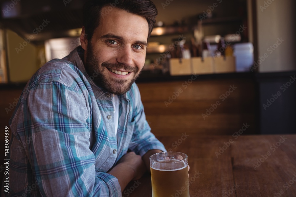 Portrait of happy man having beer
