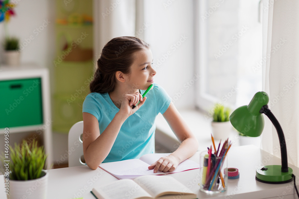 happy girl with book writing to notebook at home happy girl with book writing to notebook at home
