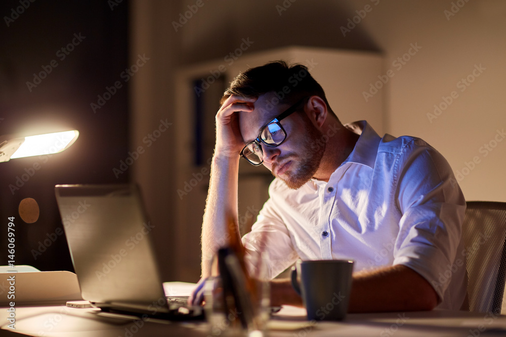 businessman with laptop thinking at night office businessman with laptop thinking at night office