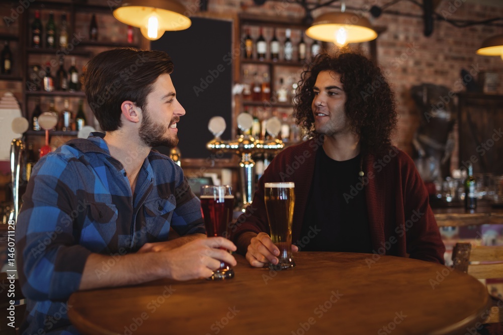 Friends having beer in pub