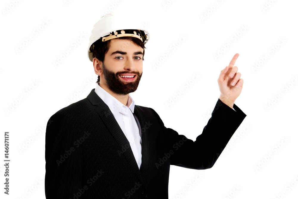 Engineer in protective helmet pointing up. Engineer in protective helmet pointing up.