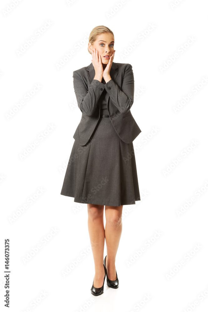 Amazed businesswoman holding hands on chin Amazed businesswoman holding hands on chin
