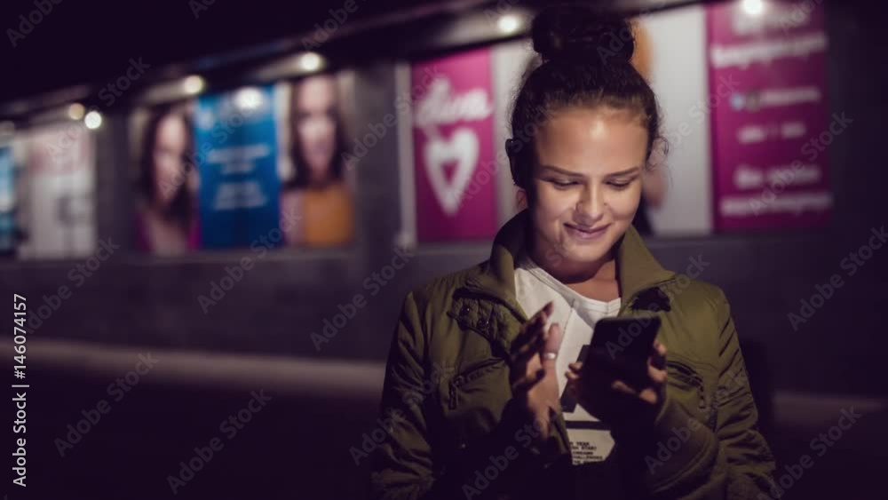 Women using smart phone while walking in the city at nigth. Urban people lifestyle background.