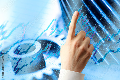 Candlestick chart, ratchets and hand photo