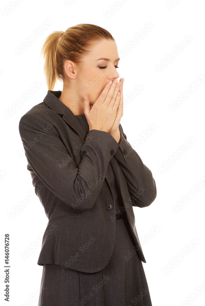 Tired young yawning business woman 