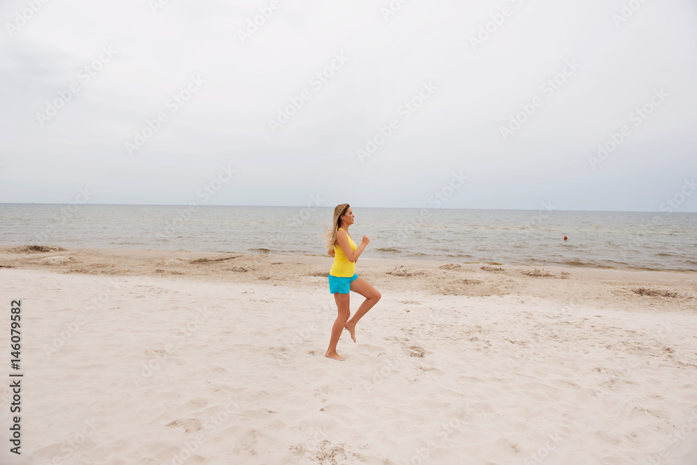 Young woman running on the beach