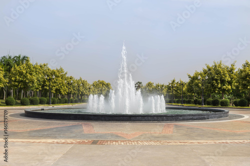 The big water fountain in the public green park.