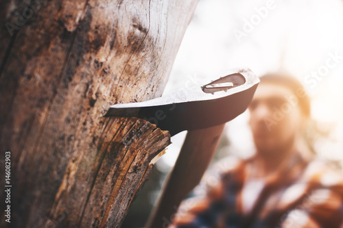 Strong lumberjack with an ax in his hands close up photo