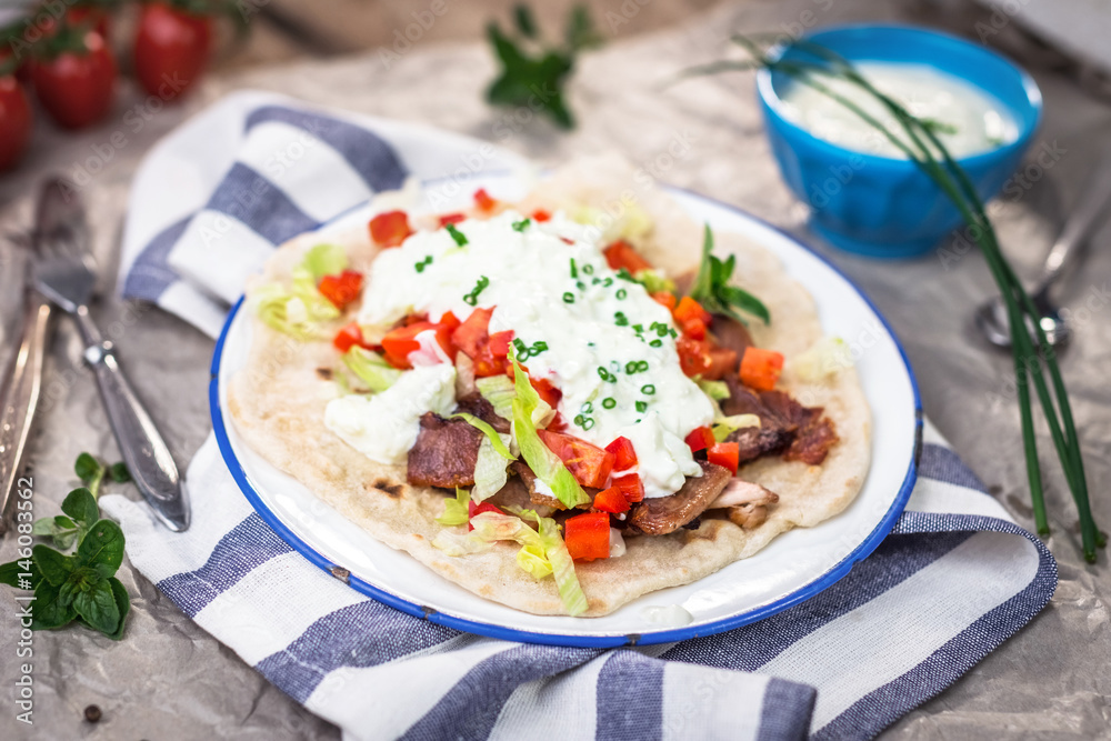 Gyros with vegetable, meat and tzatziki sauce Gyros with vegetable, meat and tzatziki sauce