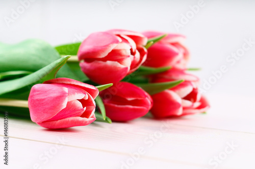 Fototapeta Naklejka Na Ścianę i Meble -  Bouquet of pink tulips on white wooden background. Top view, copy space. Happy mother's day.